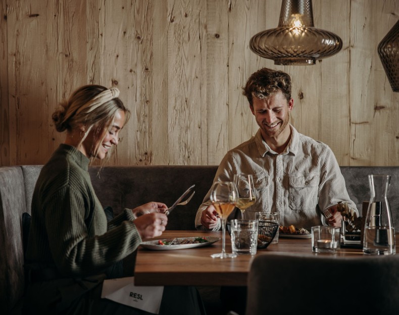 Paar sitzt am Tisch und genie&szlig;t das Abendessen